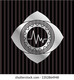 electrocardiogram icon inside silvery emblem