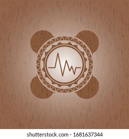 electrocardiogram icon inside wood badge or emblem