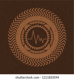 electrocardiogram icon inside wooden emblem