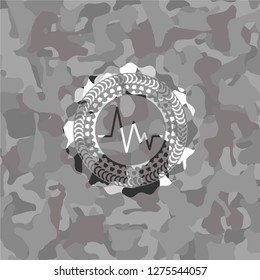 electrocardiogram icon on grey camouflage pattern