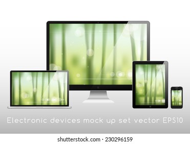 Electronic devices mockup set - laptop, monitor, tablet and smartphone vector illustration