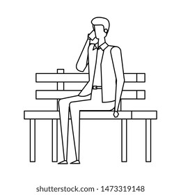 elegant businessman calling with smartphone seated in the park chair