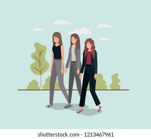 elegant businesswomen walking in the park