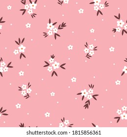 Elegante estampado floral en forma de una pequeña flor blanca. Fondo rosa. Fondo floral sin fisuras para las impresiones de moda. Textura vectorial sin inconvenientes. Ramo de primavera.