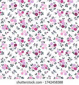 Elegante estampado floral en pequeñas flores lilas y rosas. Estilo de la libertad. Fondo floral sin fisuras para las impresiones de moda. Impresión Ditsy. Textura vectorial sin inconvenientes. Ramo de primavera.