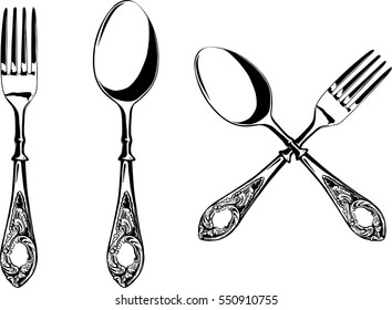 Elegant fork and spoon with decorated hilts isolated on white background