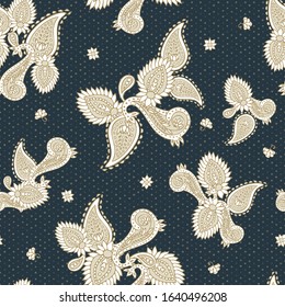 Elegant golden paisley ethnic seamless vector pattern on dark gray dotted background for fabric, wallpaper, scrapbooking projects or backgrounds. Surface pattern background.