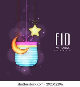 Elegant greeting card design decorated with shiny gift box, hanging crescent moon and star on purple background for holy Islamic festival, Eid celebration.