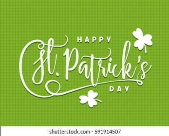 Elegant greeting card with Happy St. Patrick's Day lettering design and shamrock leaves on green background. 