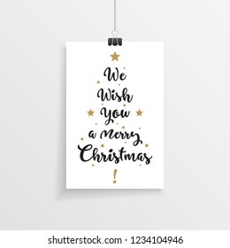 Elegant hanging christmas card with we wish you a merry christmas hand drawn text in a christmas tree layout.