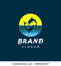 Elegant logo two dolphins jumping at sunset in the ocean. Dolphin brand logo design template