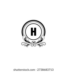 Elegant Monogram Logo with Beautiful Circular Frame. The stylish letters sit in the center of a circular frame, decorated with intricate symmetrical carvings at the bottom
