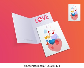 Elegant open greeting card with colorful hearts for Happy Valentines Day celebration on glossy colorful background.