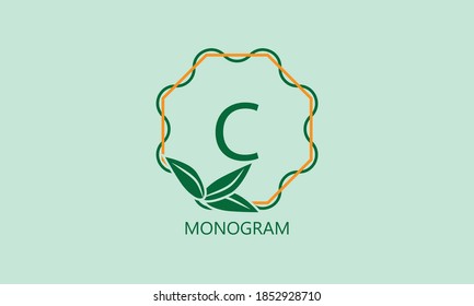 Elegant round monogram with green leaves and the letter C. Exquisite floral logo of the emblem of women's clothing, flower shop, beauty salon.