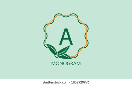 Elegant round monogram with green leaves and the letter A. Exquisite floral logo of the emblem of women's clothing, flower shop, beauty salon.