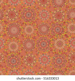 Elegant seamless pattern with floral and Mandala elements. Nice yellow, brown and red hand-drawn seamless vector illustration.