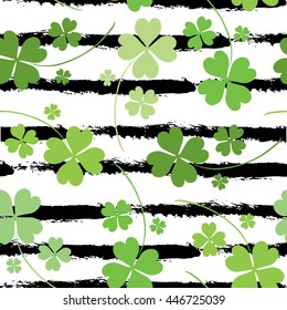 Elegant seamless pattern with hand drawn decorative fourleaf clovers, design elements. Can be used for invitations, greeting cards, scrapbooking, print, gift wrap, manufacturing. Stripe background