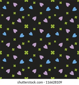 Elegant seamless pattern, purple and blue hearts and lucky green shamrocks on black background.