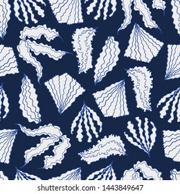 Elegant seamless pattern with stylized hand-drawn seashells and algae on dark blue background. Modern trendy exotic design for wallpaper, textiles, fabric.