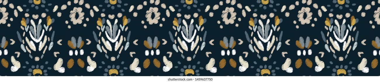 Elegant seamless pattern in vintage style. Ethnic oranment embroidered with silver and gold threads on a dark background. Tribal ethnic vector texture.