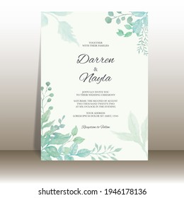 Elegant wedding invitation card with watercolor leaf ornaments