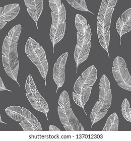 Elegant white feathers on black background. Seamless vector pattern.