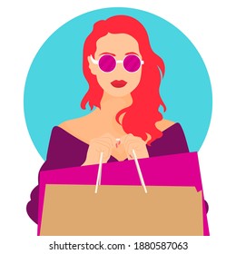 Elegant woman in sunglasses holding shopping bags on blue color background