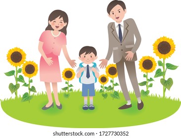 Elementary school boy with his parents.They are smiling in front of sunflowers.