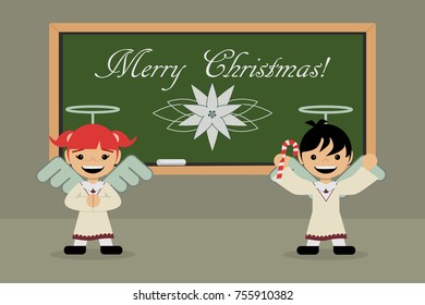 elementary school, children with angels costume, on the green blackboard there is a Christmas flower and the message Merry Christmas