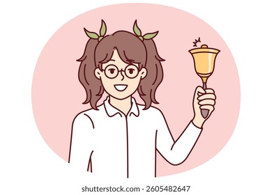 Elementary school girl holds bell for start of academic year and looks at screen smiling. Little schoolgirl rejoices at beginning of lessons and end of summer holidays, for concept of back to school