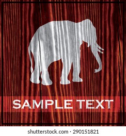 Elephant silhouette painted on wooden board with white paint