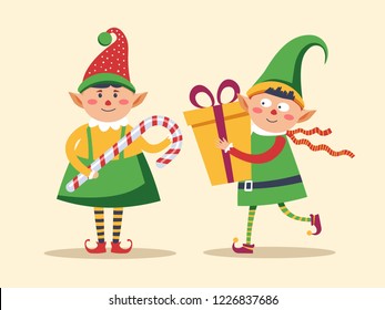 Elf children holding presents decorated with bow and candy vector. Leprechaun boys wearing traditional clothes with hats and boots. Santa Claus helpers with lollipop and gift in wrapping with ribbons