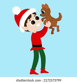 An elf holds a dog in his hands. Santa's helper is dressed in a red and green ivory. Christmas character is happy and smiling.