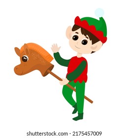 An elf rides a toy horse on a stick. The boy waves hello he is happy. The child is wearing traditional elf clothing. Cartoon Christmas illustration isolated on white background.
