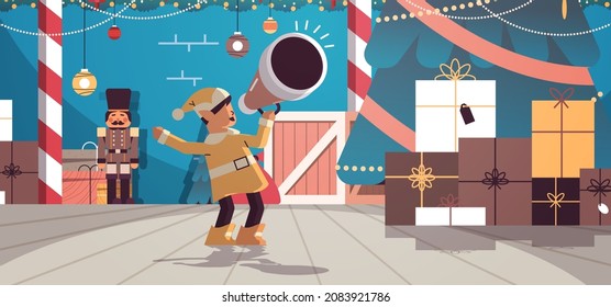 elf shouting in megaphone santa helper making announcement new year and christmas holidays celebration