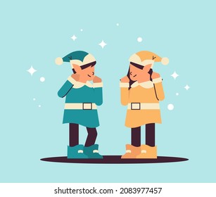 elves in uniform having fun girl and boy santa helpers celebrating happy new year merry christmas holidays