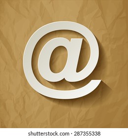 email symbol long shadow on a crumpled paper brown background