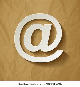 email symbol long shadow on a crumpled paper brown background