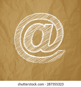email symbol scribble on a crumpled paper brown background
