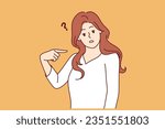 Embarrassed woman points finger at herself and looks puzzled at screen after hearing strange question. Embarrassed girl feels awkward because of incorrect statement or accusation against her