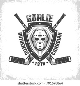 Emblem with canadian hockey retro mask on triangular shield on background of crossed goalies. Worn texture on separate layer and can be turned off.