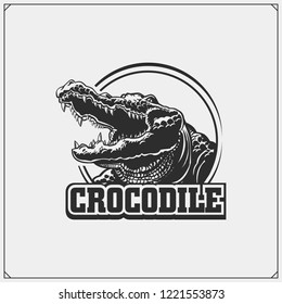 The emblem with crocodile. Vector monochrome illustration.