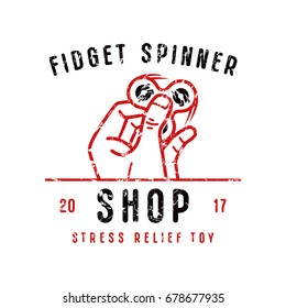 Emblem for fidget spinner shop. Image of hand holding fidget toy. Graphic design for t-shirt. Color print on white background