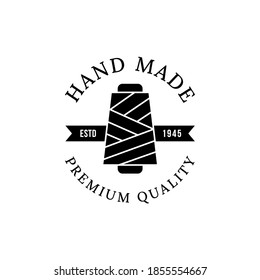 Emblem of hand made concept with thread spool icon Premium Vector. Yarn spool  logo.