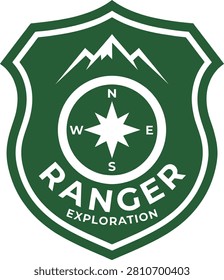 Emblematic shield design featuring a compass and mountains, symbolizing exploration and adventure