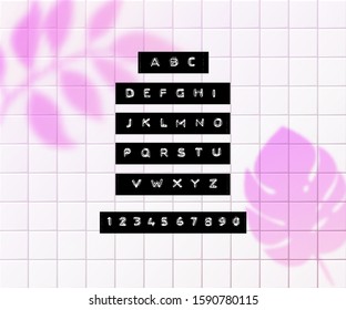 Embossed letters tape font. Vintage adhesive label type. Vector alphabet on tiles background with pink tropic palm leaves overlay