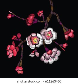 Embroidered blooming branch. Cherry branch, apple or sakura with flowers and buds on a black background. Vector illustration for embroidery, patches and stickers