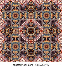 Embroidered colorful seamless pattern. Stitched ethnic design with flowers, leafs and Mandalas. Vector fashion embroidery imitation in black, gray and orange colors for prints or fabric.