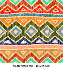 Embroidered ethnic seamless pattern. Aztec and tribal motifs. Striped mexican ornament hand drawn. Green, blue, red, orange and blue colors. Print in the bohemian style. Vector illustration.