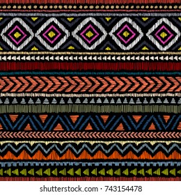 Embroidered ethnic seamless pattern. Aztec and tribal motifs. Striped ornament hand drawn. Print in the bohemian style. Vector illustration.